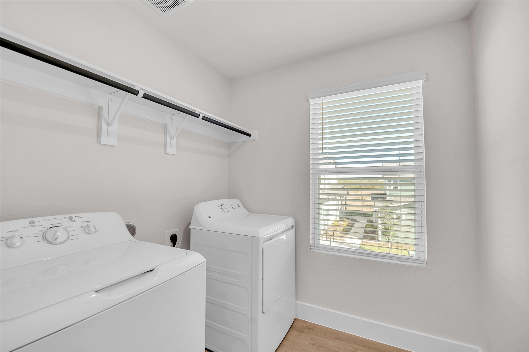 9312 Curious Squirrel Street Austin, TX 78744 - Photo 21 of 22 a view of storage and utility room with washer and dryer