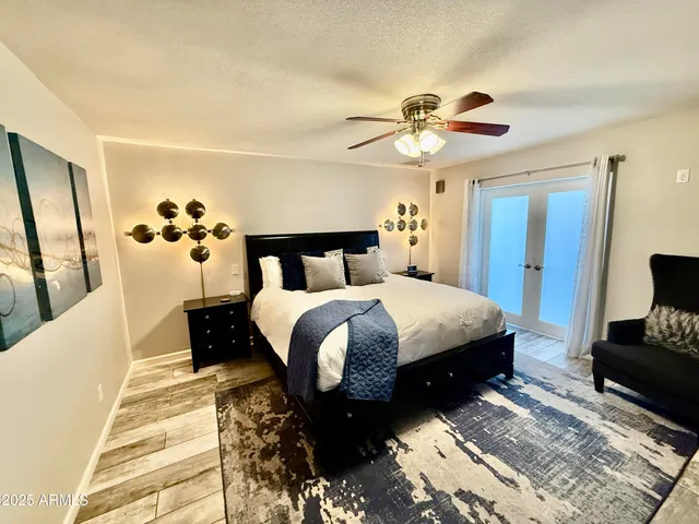 a bedroom with a bed and a chandelier