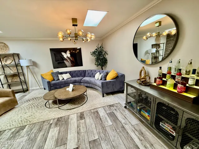 a living room with furniture and a chandelier