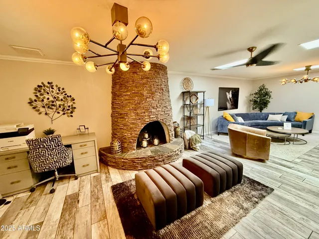 a living room with furniture fireplace and wooden floor