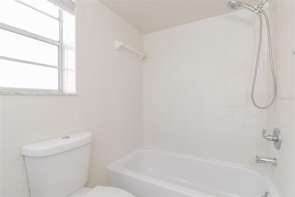 12125 Shadow Ridge Boulevard Hudson, FL 34669 - Photo 17 of 21 a bath tub sitting next to a white toilet and a shower