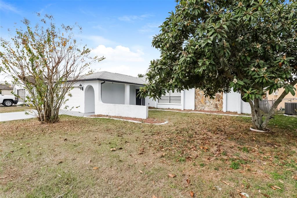 12125 Shadow Ridge Boulevard Hudson, FL 34669 - Photo 2 of 21 a view of a house with a tree