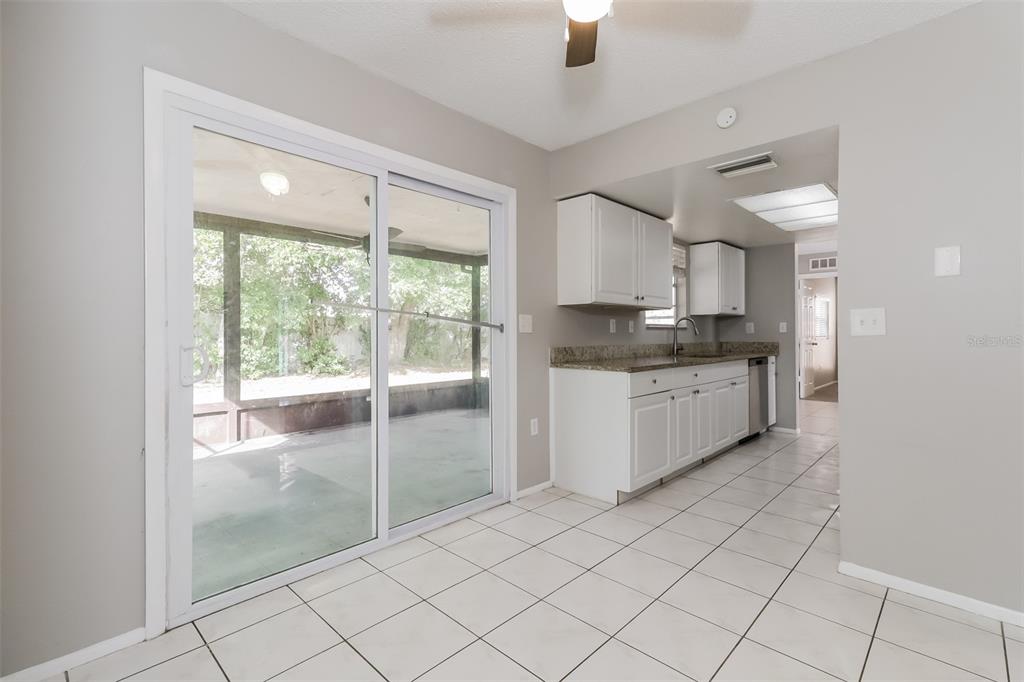 12125 Shadow Ridge Boulevard Hudson, FL 34669 - Photo 6 of 21 a kitchen with granite countertop a stove a sink and a refrigerator