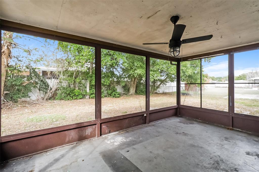 12125 Shadow Ridge Boulevard Hudson, FL 34669 - Photo 10 of 21 a view of an empty room with wooden floor and a floor to ceiling window
