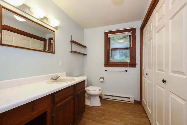 a bathroom with a sink mirror and toilet