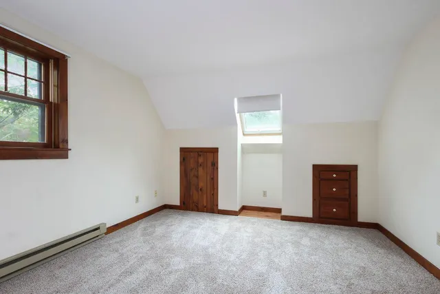 an empty room with windows and closet