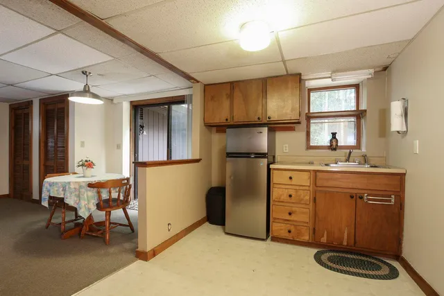 a kitchen with a refrigerator and a sink