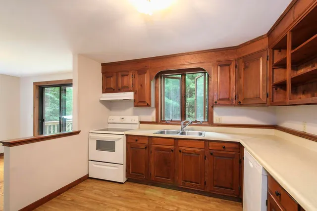 a kitchen with a sink cabinets and window