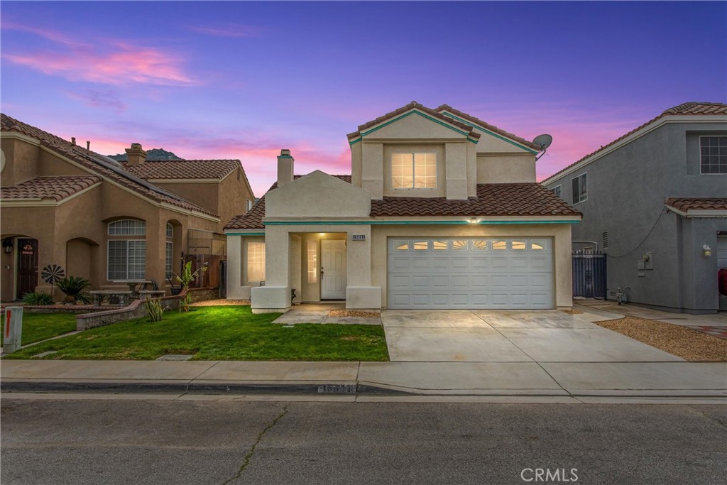 15811 Fiddleleaf Road Fontana, CA 92337 - Photo 1 of 1 a front view of a house with a yard and garage