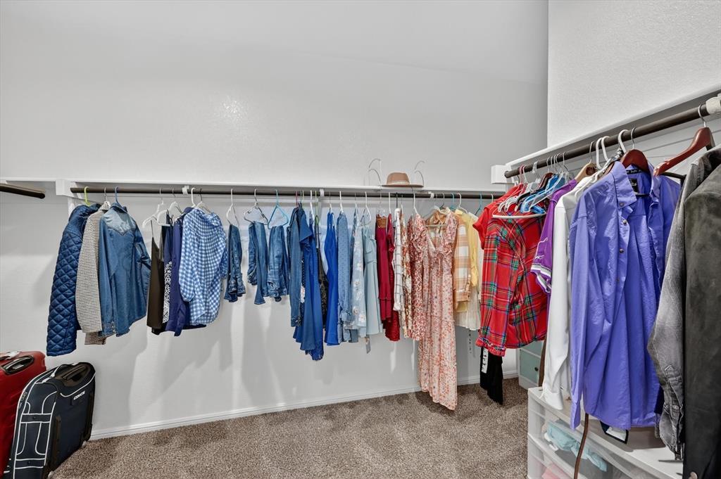 9604 Cherryville Road Fort Worth, TX 76108 - Photo 22 of 40 Custom closet with ample hanging storage, light-toned walls, and neutral carpet flooring