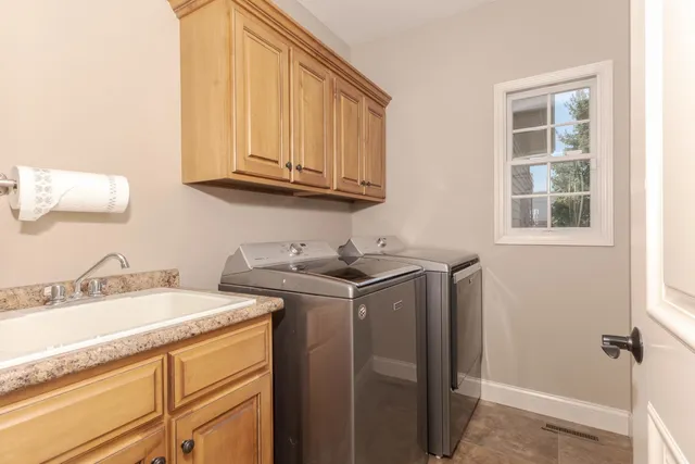 a bathroom with double sink and a mirror