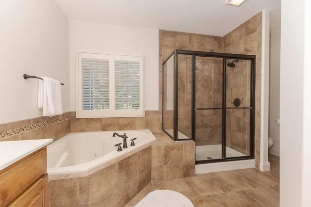 a bathroom with a bathtub and a shower