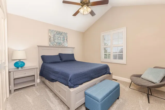 a bedroom with a bed and chair