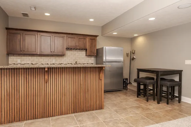 a kitchen with stainless steel appliances granite countertop refrigerator sink and cabinets