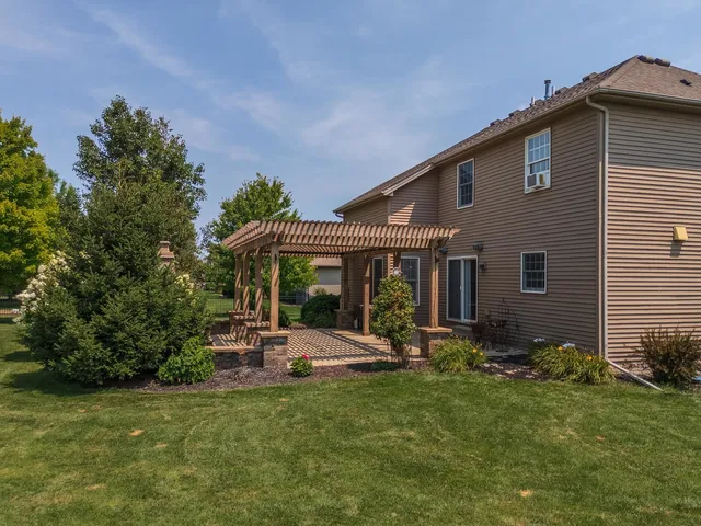 a backyard of a house with table and chairs