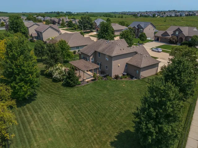 an aerial view of a house with outdoor space and lake view