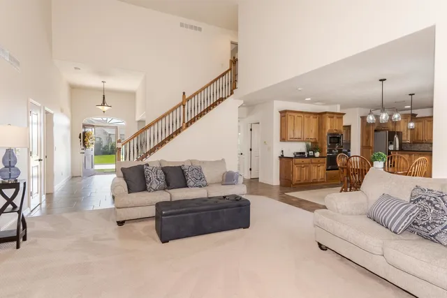 a living room with furniture and a view of kitchen