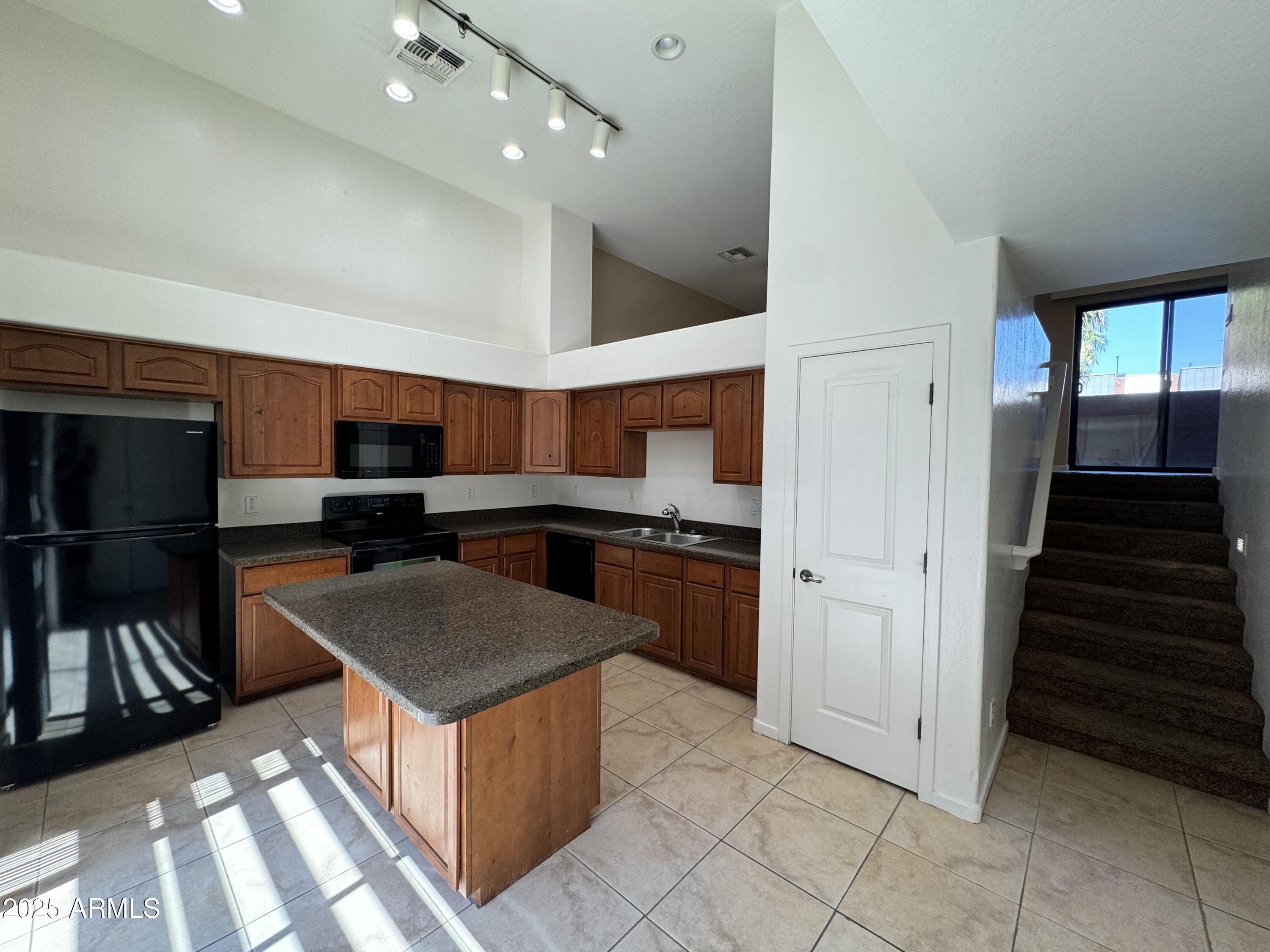 305 South Wilson Street, Unit 111 Tempe, AZ 85281 - Photo 5 of 48 a kitchen with stainless steel appliances granite countertop a refrigerator and a sink