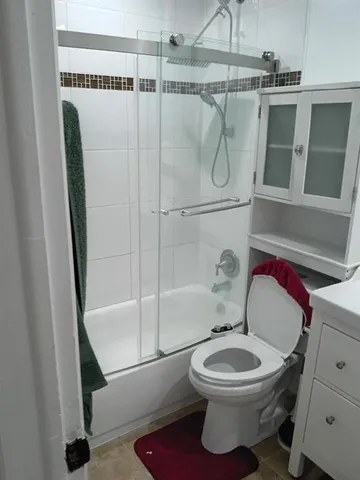 a bathroom with a toilet and a shower