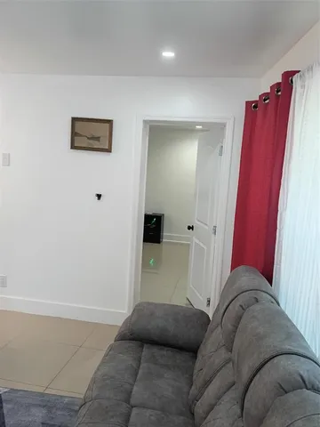 a living room with furniture and a red gate