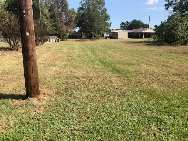 a view of a swimming pool with an outdoor seating and a yard