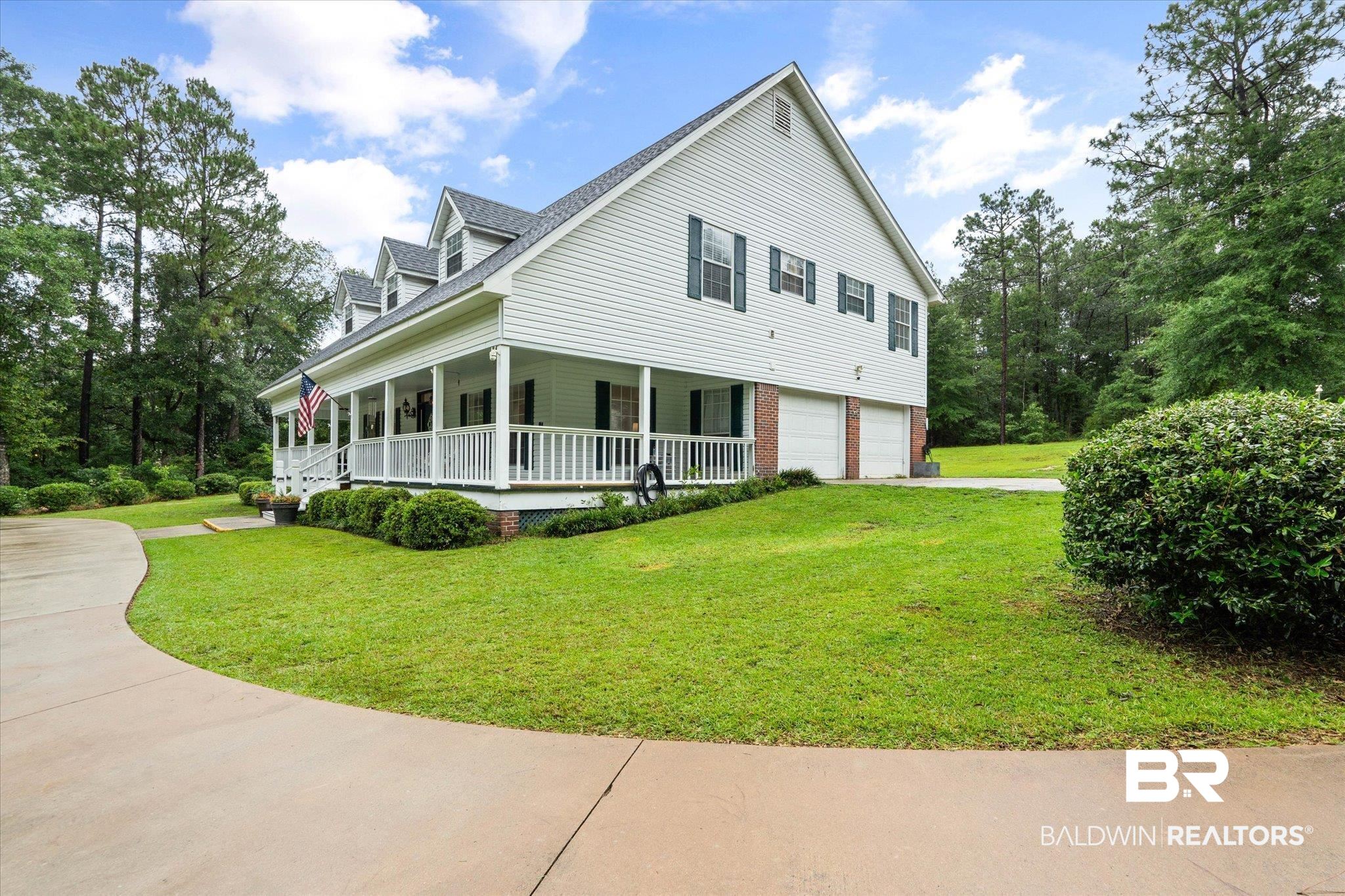 2300 Radcliff Road Saraland, AL 36571 - Photo 41 of 56 View of property exterior with a porch, a garage, a yard, and driveway