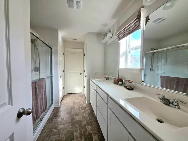 a bathroom with a sink a mirror and a shower