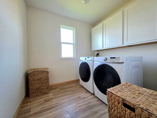 a view of a room with wooden floor and cabinet