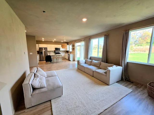 a living room with furniture and a wooden floor