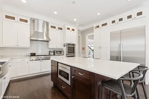 a kitchen with a table chairs refrigerator and cabinets