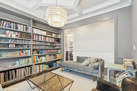a living room with furniture and a book shelf