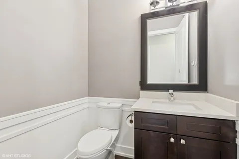 a spacious bedroom with a bed and a chair