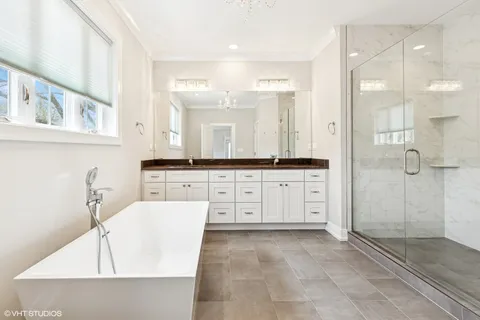a large bathroom with a large mirror vanity and shower