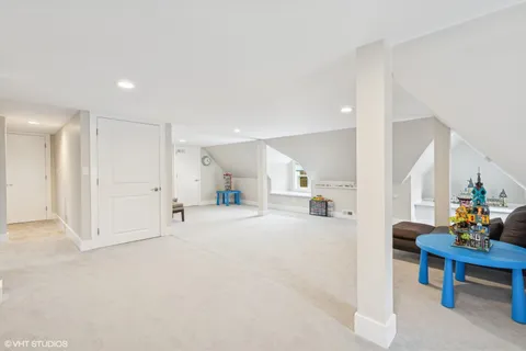 a view of an empty room with stairs and toys