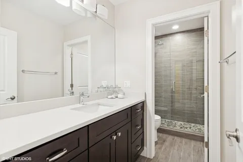 a living room with furniture a table and kitchen view
