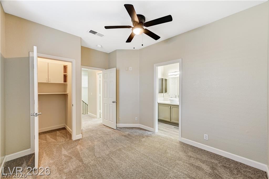 2283 Ramsgate Drive Henderson, NV 89074 - Photo 31 of 51 Plush carpeting and an attached bathroom define this comfortable bedroom space.
