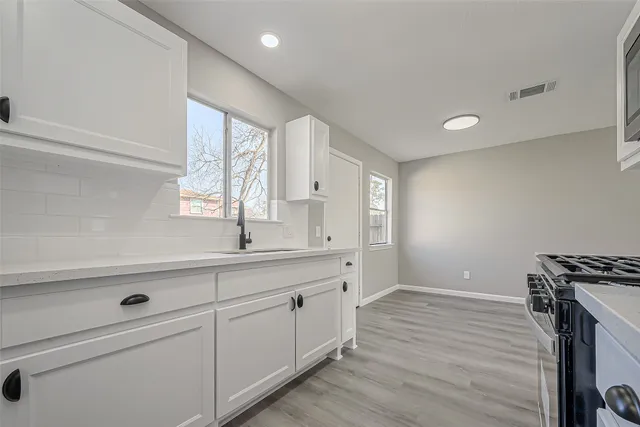 a view of a kitchen counter space with wooden floor