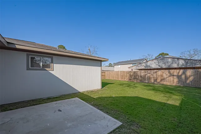 a view of a house with a yard and a fence