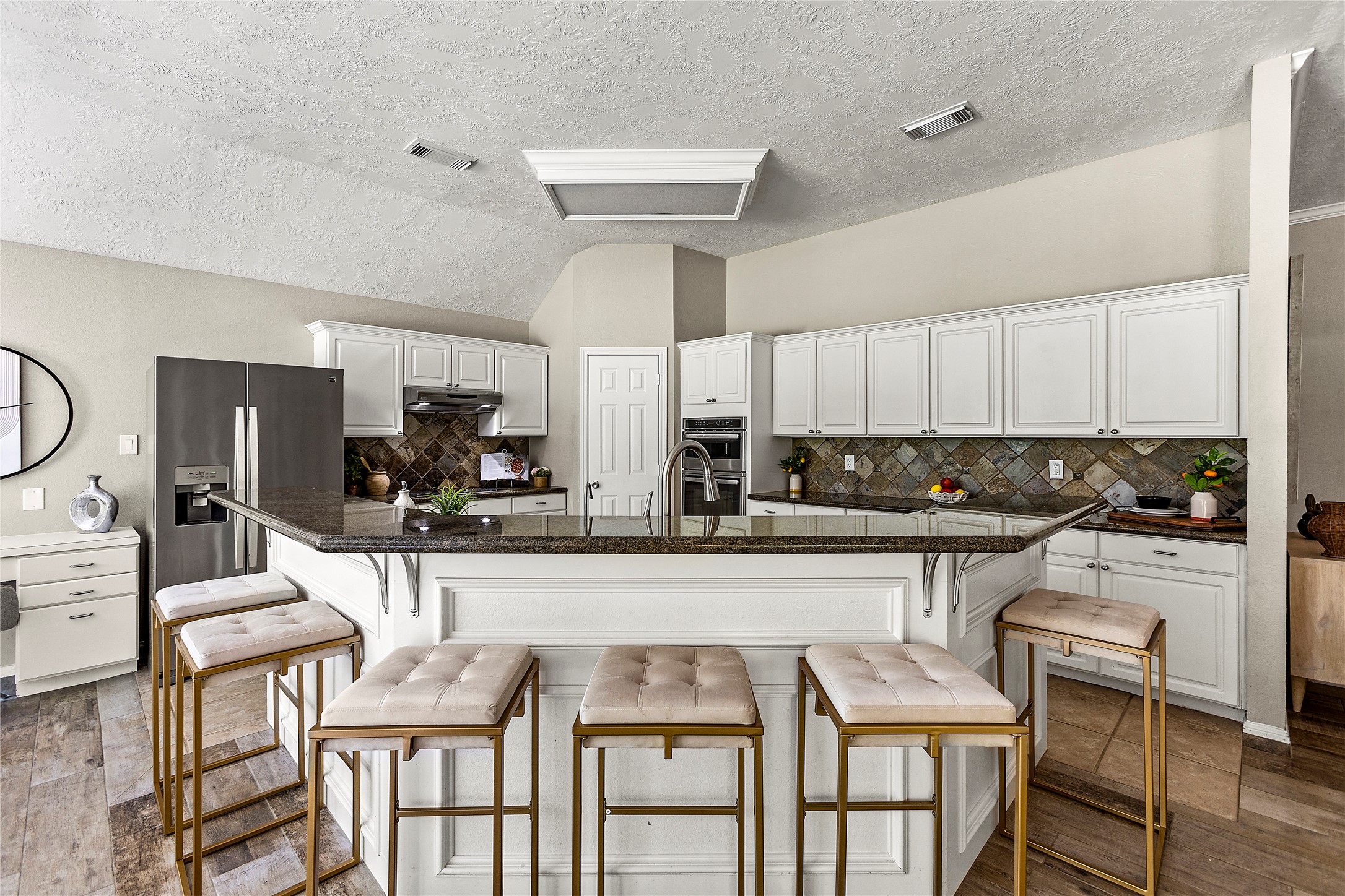 170 April Cove Conroe, TX 77356 - Photo 15 of 50 a kitchen with granite countertop a table chairs stove and cabinets