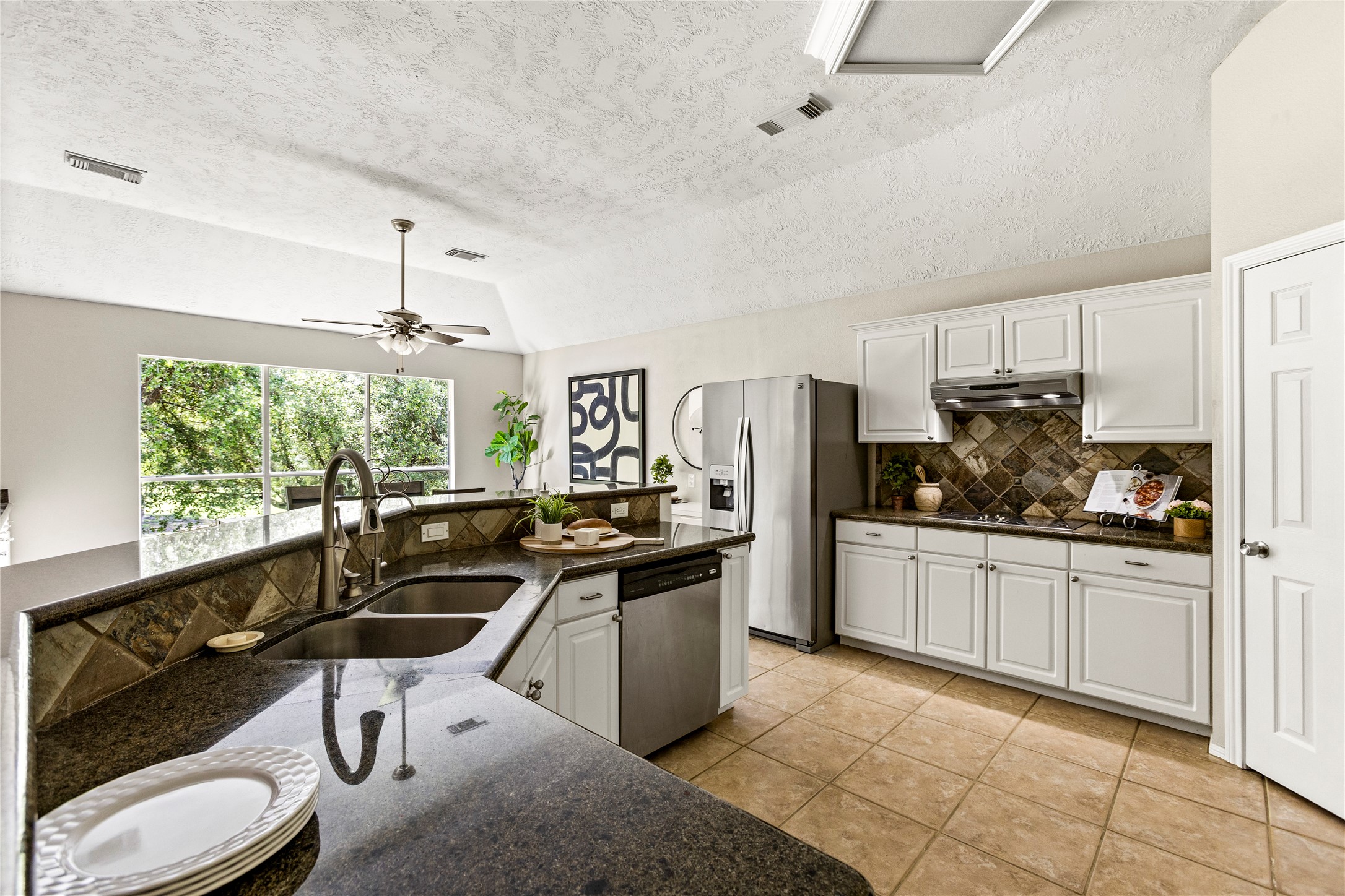 170 April Cove Conroe, TX 77356 - Photo 16 of 50 a kitchen with stainless steel appliances granite countertop a sink a stove and refrigerator