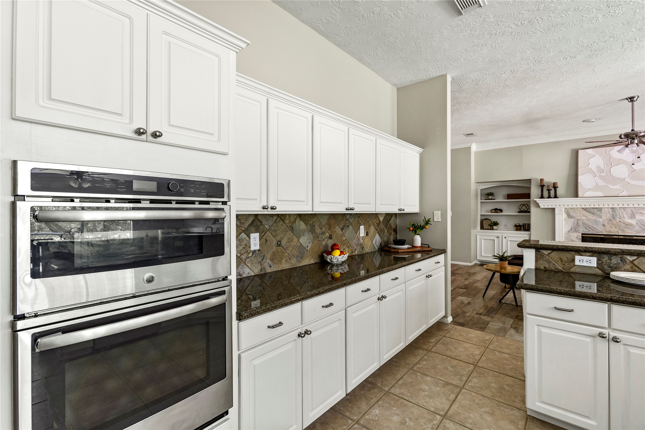 170 April Cove Conroe, TX 77356 - Photo 17 of 50 a kitchen with stainless steel appliances white cabinets and a stove a oven with white countertops