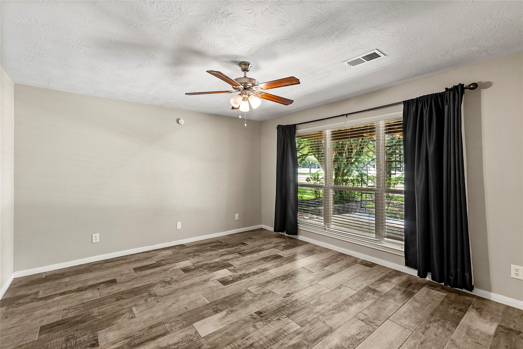 170 April Cove Conroe, TX 77356 - Photo 36 of 50 a view of a room with a ceiling fan and window