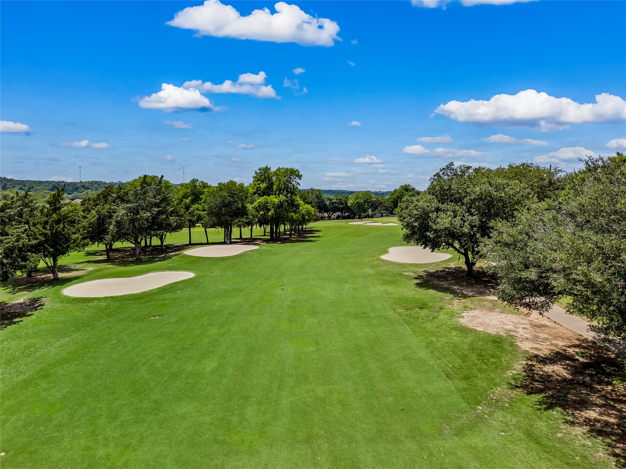 170 April Cove Conroe, TX 77356 - Photo 48 of 50 a view of a golf course with a lake