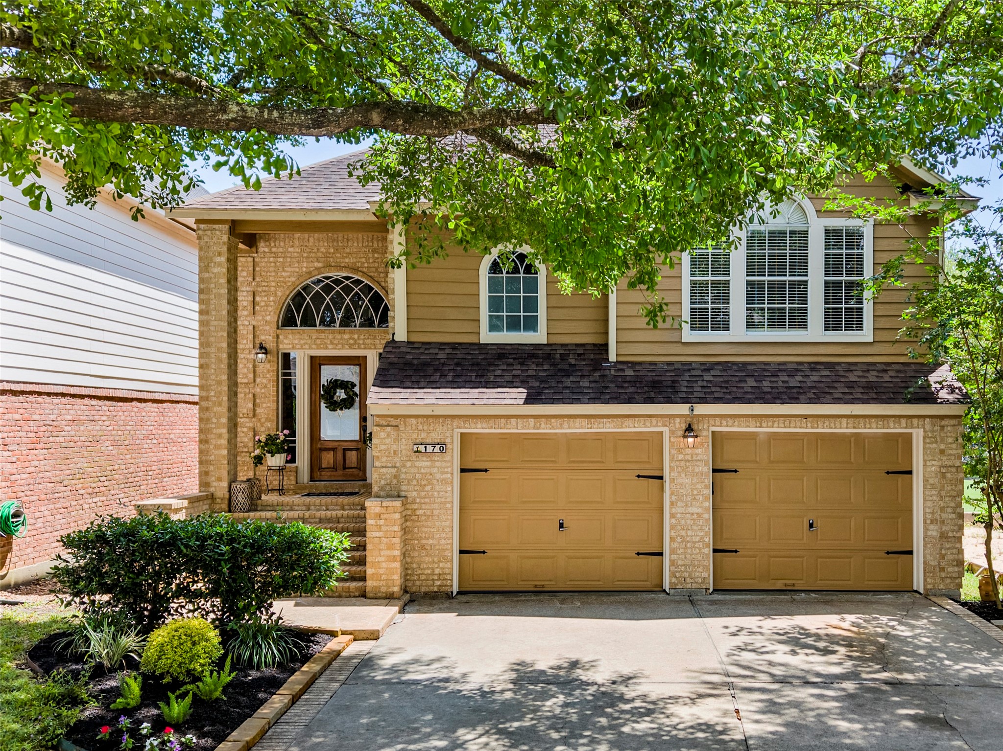 170 April Cove Conroe, TX 77356 - Photo 5 of 50 a front view of a house with a garden