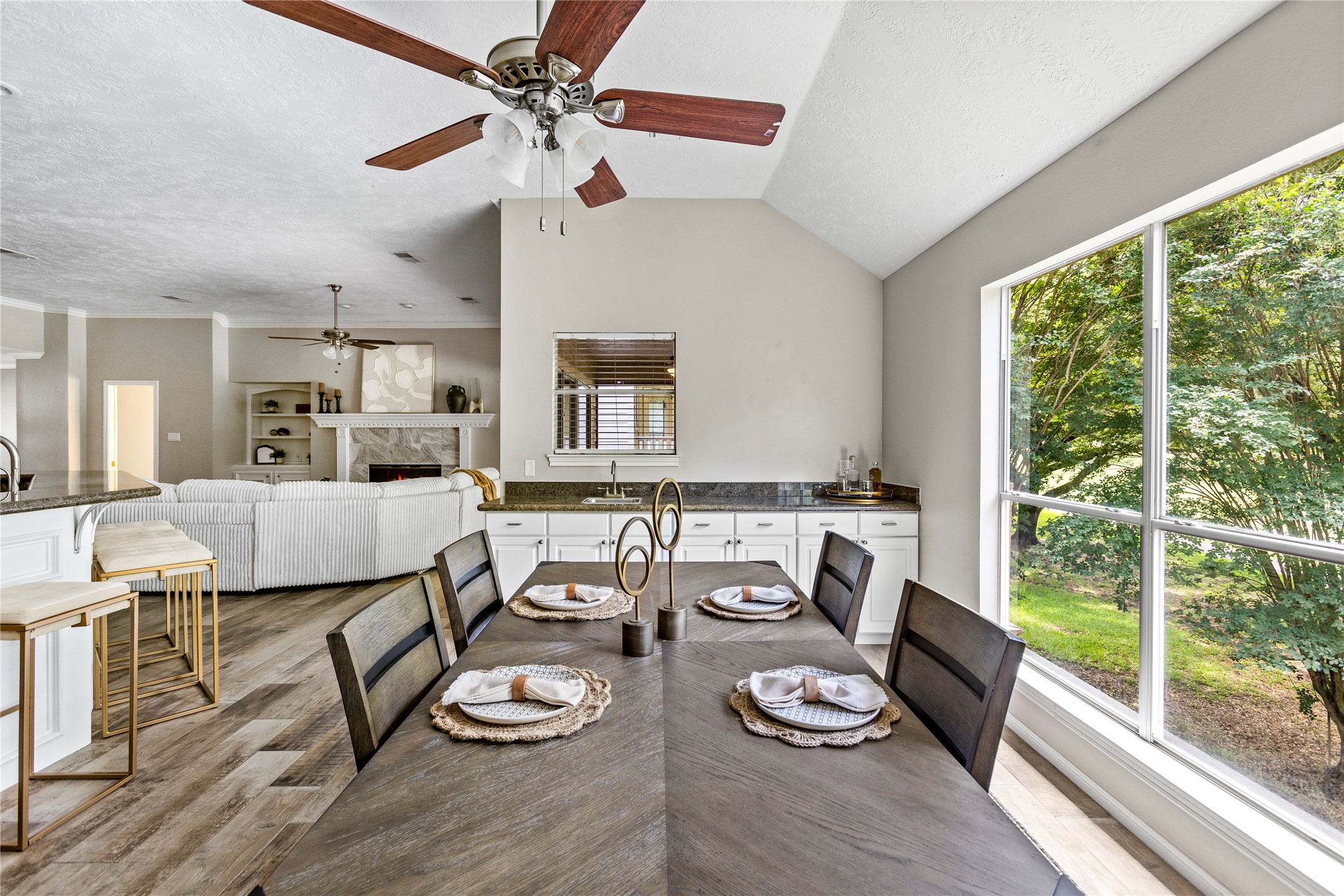 170 April Cove Conroe, TX 77356 - Photo 10 of 50 a living room with white couches and a dining table with wooden floor