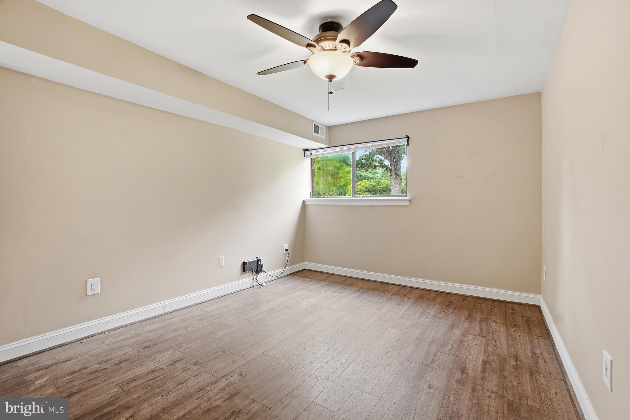 8487 Greenbelt Road Greenbelt, MD 20770 - Photo 19 of 29 an empty room with windows and ceiling fan
