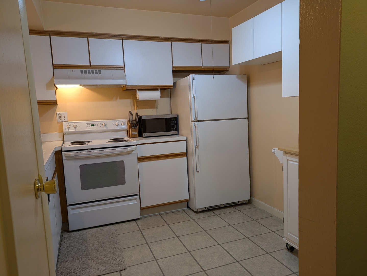 1808 Plum Grove Road, Unit 1D Rolling Meadows, IL 60008 - Photo 4 of 10 a kitchen with a refrigerator sink stove and cabinets
