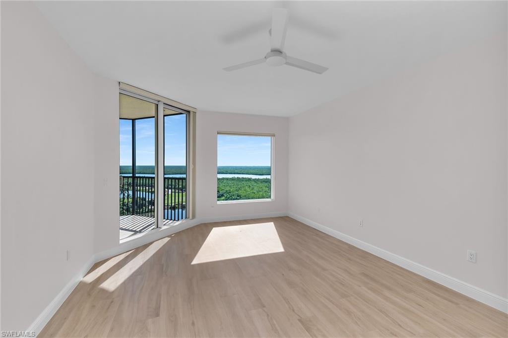 1060 Borghese Lane, Unit 803 Naples, FL 34114 - Photo 11 of 46 Empty room with light wood-style floors and ceiling fan