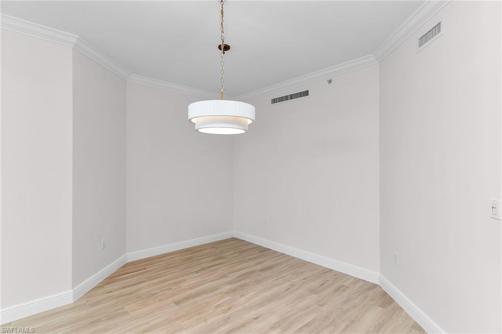 1060 Borghese Lane, Unit 803 Naples, FL 34114 - Photo 21 of 46 Spare room with light wood finished floors and ornamental molding