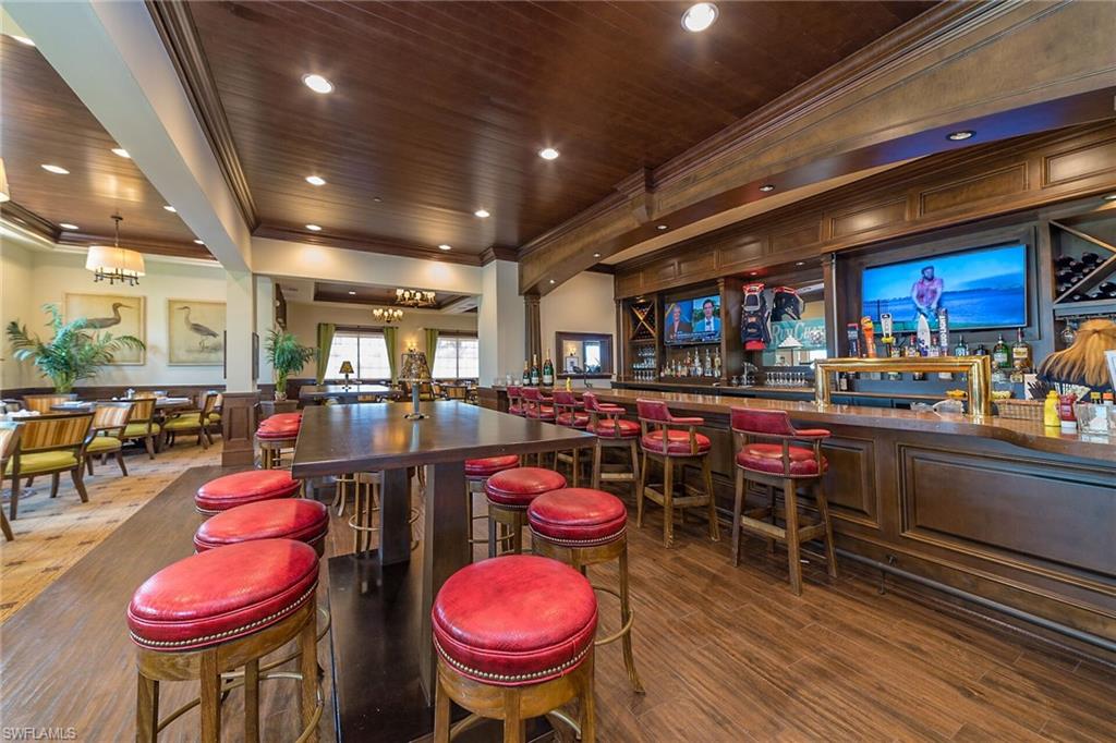 1060 Borghese Lane, Unit 803 Naples, FL 34114 - Photo 39 of 46 Bar with wood ceiling, crown molding, and pendant lighting